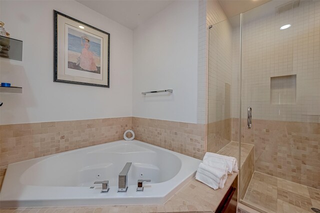 bathroom featuring shower with separate bathtub