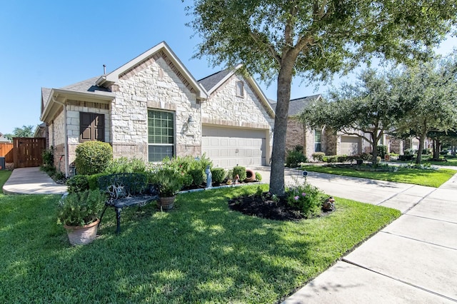 french country inspired facade featuring stone siding, concrete driveway, an attached garage, and a front lawn