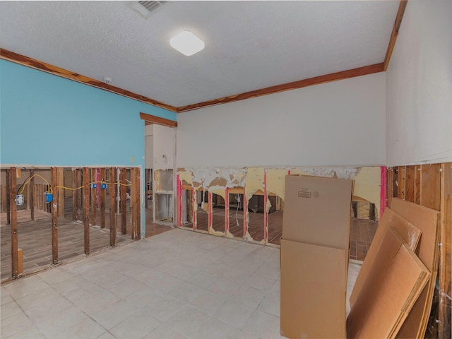 misc room with ornamental molding and a textured ceiling