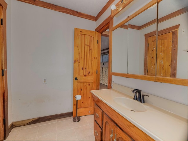 bathroom featuring crown molding, tile patterned flooring, and vanity