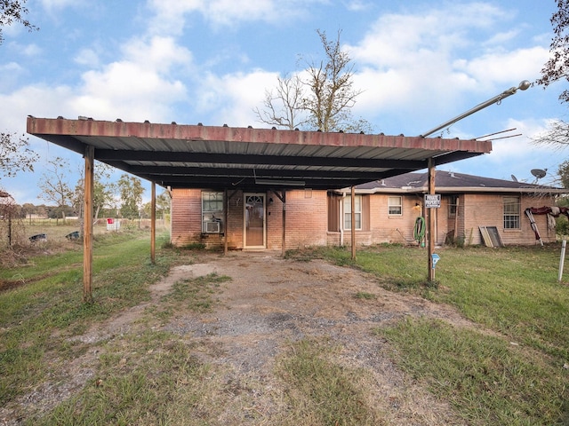 rear view of property featuring a lawn