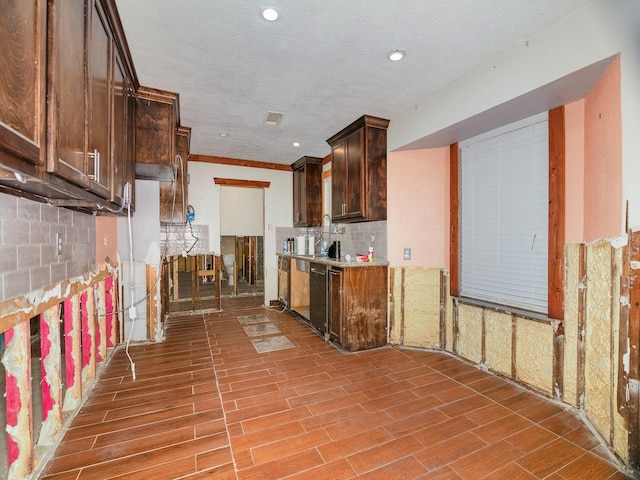 kitchen featuring dishwasher, a textured ceiling, tasteful backsplash, light hardwood / wood-style floors, and dark brown cabinetry