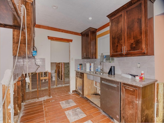 kitchen with dishwasher, ornamental molding, sink, and tasteful backsplash