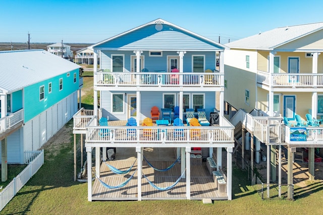 back of property with a yard, fence, and a residential view