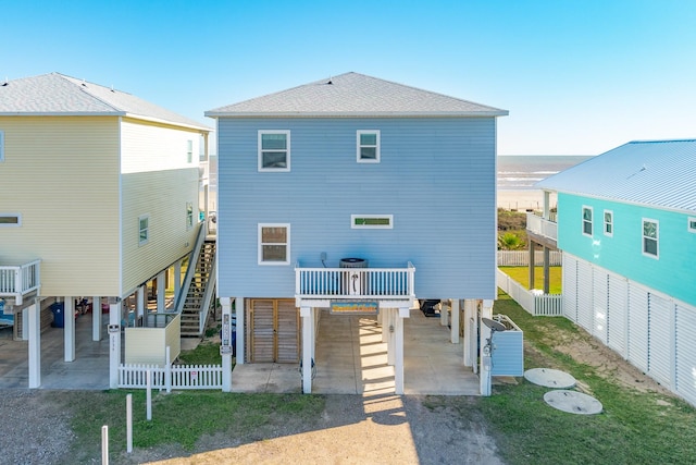 rear view of house featuring a water view and a carport