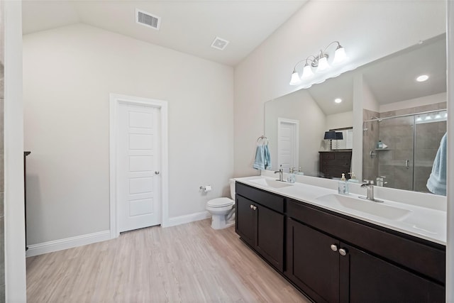 bathroom featuring an enclosed shower, hardwood / wood-style flooring, toilet, vanity, and lofted ceiling