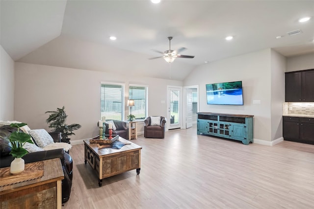 living room featuring light hardwood / wood-style floors, vaulted ceiling, and ceiling fan