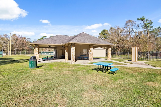 exterior space with ceiling fan, a yard, and a patio