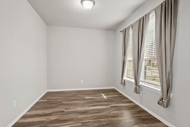 spare room featuring dark hardwood / wood-style floors