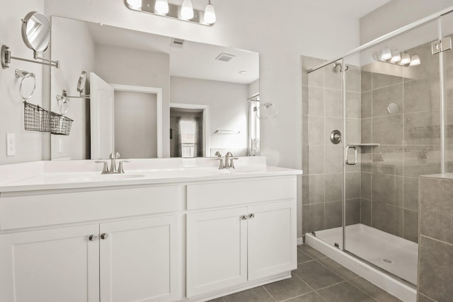 bathroom with tile patterned floors, vanity, and a shower with shower door