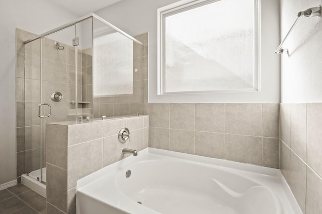 bathroom featuring tile patterned flooring and separate shower and tub