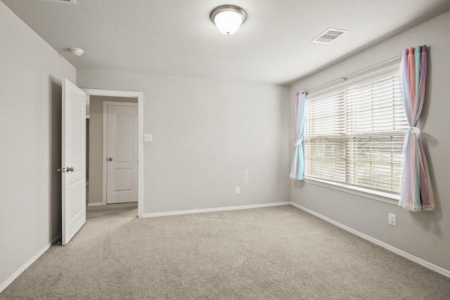 spare room with light colored carpet