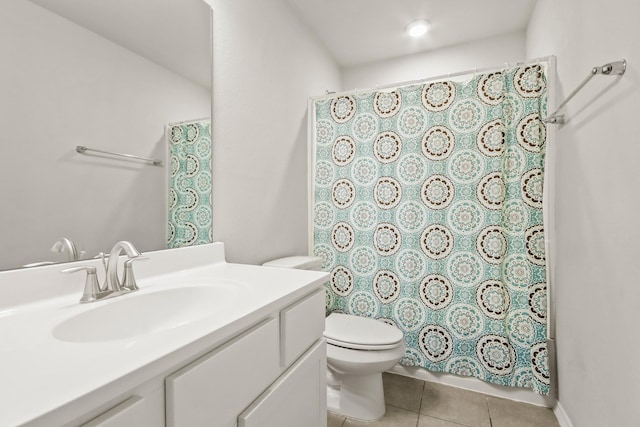 bathroom featuring tile patterned floors, vanity, and toilet