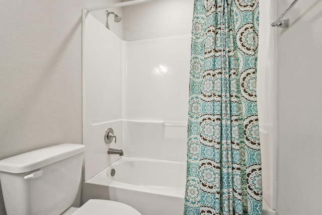 bathroom featuring shower / bath combo and toilet