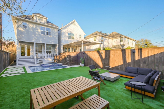 back of house with a yard, a swimming pool, an outdoor hangout area, and a patio