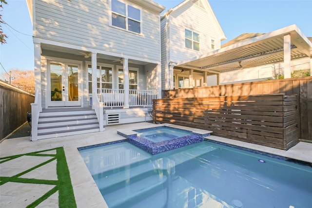 view of pool with an in ground hot tub, a patio, and french doors