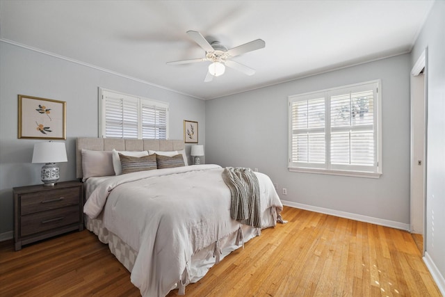 bedroom featuring crown molding, ceiling fan, and light hardwood / wood-style flooring