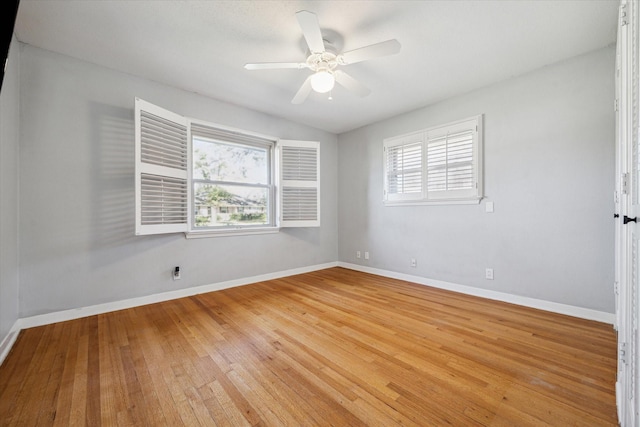 unfurnished room with light wood-style floors, plenty of natural light, baseboards, and a ceiling fan