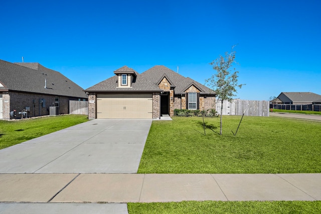 view of front of home featuring central AC, a garage, and a front lawn