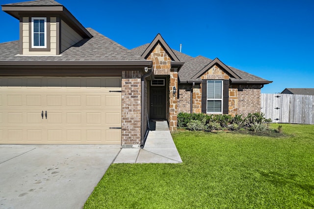 view of front of house with a garage and a front lawn