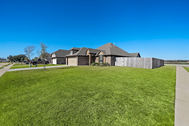 view of front of home featuring a front lawn and a garage