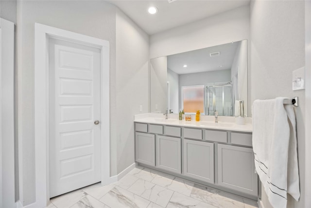 bathroom featuring vanity and a shower with shower door