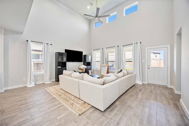 living room featuring ceiling fan and light hardwood / wood-style flooring