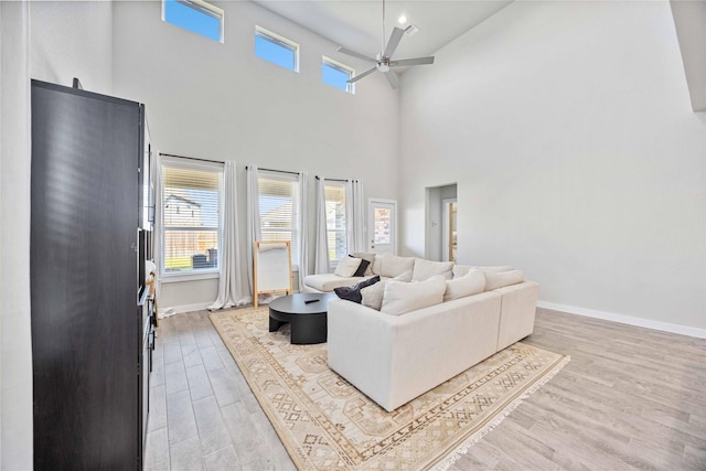 living room featuring ceiling fan and light hardwood / wood-style flooring