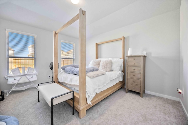 bedroom featuring light carpet and baseboard heating