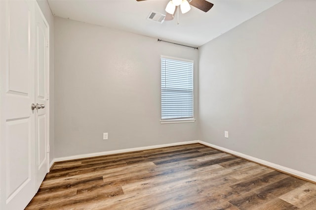 spare room with ceiling fan and dark wood-type flooring