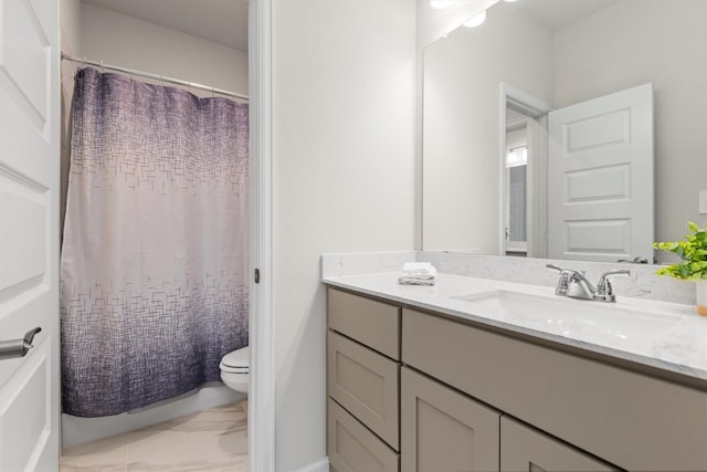 bathroom featuring vanity, toilet, and walk in shower