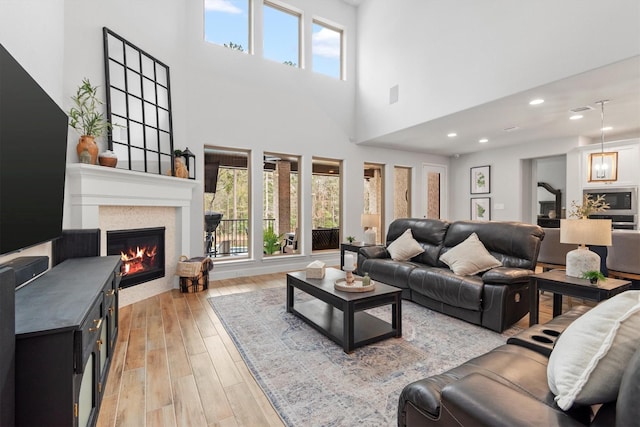 living room featuring a towering ceiling and a wealth of natural light