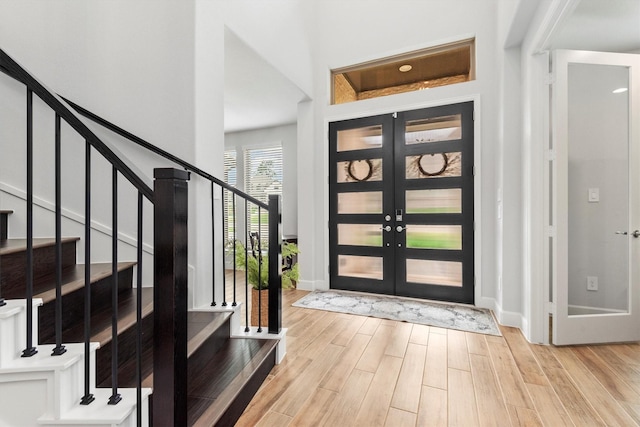 entrance foyer with light wood-type flooring and french doors