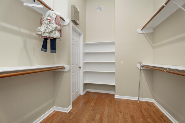 walk in closet with wood finished floors and visible vents