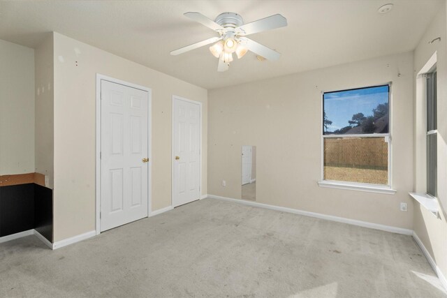 unfurnished bedroom featuring baseboards, carpet floors, and a ceiling fan