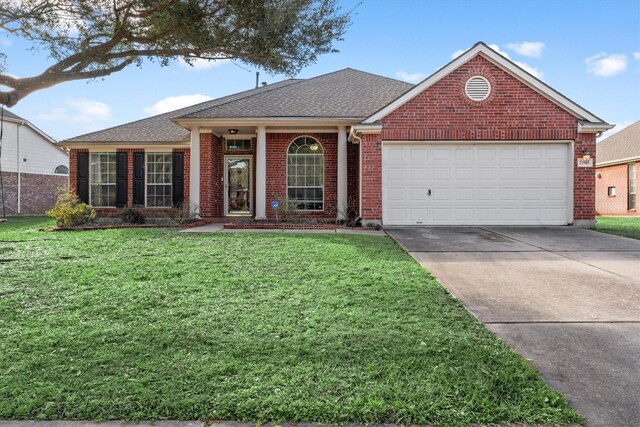 view of front facade with a front lawn and a garage