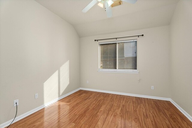 unfurnished room featuring a ceiling fan, lofted ceiling, baseboards, and light wood-type flooring