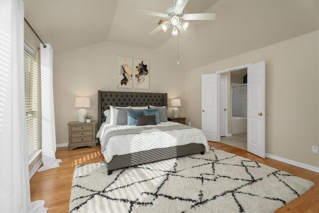 bedroom featuring vaulted ceiling, a ceiling fan, baseboards, and light wood finished floors