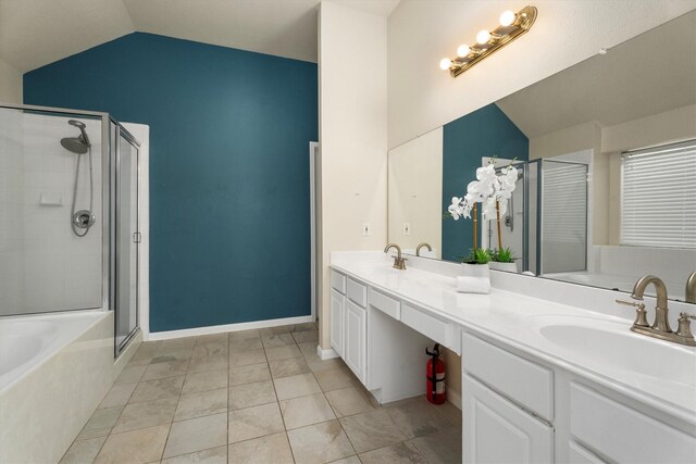 bathroom featuring a sink, lofted ceiling, a stall shower, and double vanity