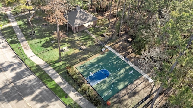 view of basketball court with community basketball court and a lawn