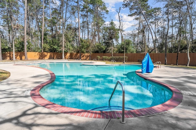 view of swimming pool featuring a patio area, a fenced in pool, and a fenced backyard