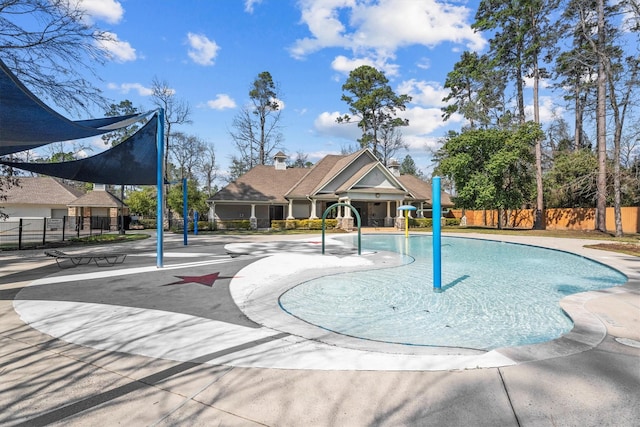 view of pool featuring fence