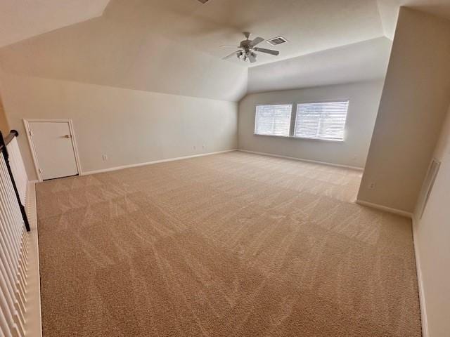 additional living space featuring ceiling fan, light carpet, and vaulted ceiling