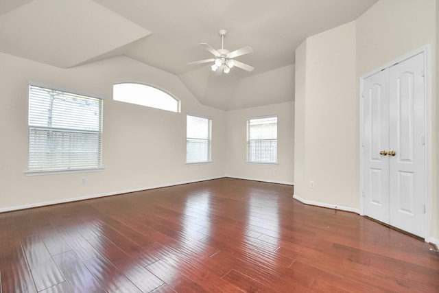 unfurnished room featuring ceiling fan, dark wood-type flooring, and lofted ceiling