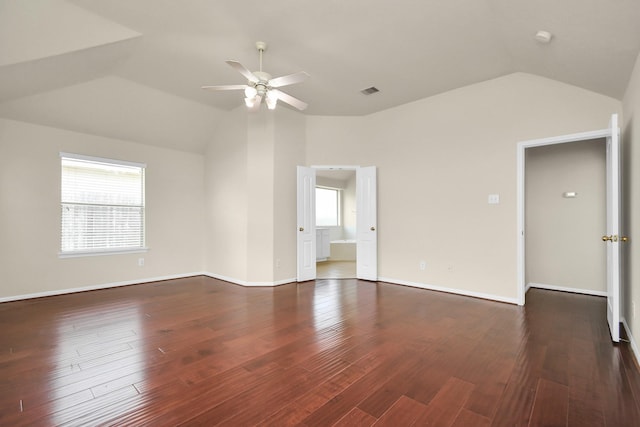 empty room featuring dark hardwood / wood-style floors, a wealth of natural light, and ceiling fan