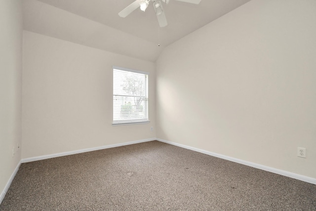 carpeted empty room with ceiling fan and vaulted ceiling