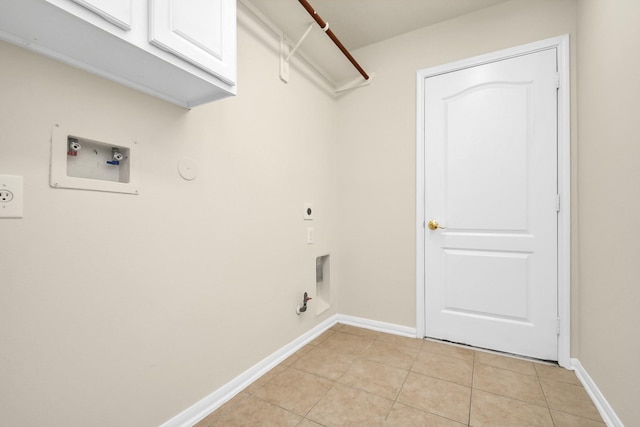 clothes washing area with cabinets, electric dryer hookup, hookup for a gas dryer, hookup for a washing machine, and light tile patterned flooring