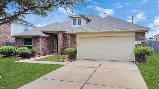 view of front of home with a garage and a front lawn