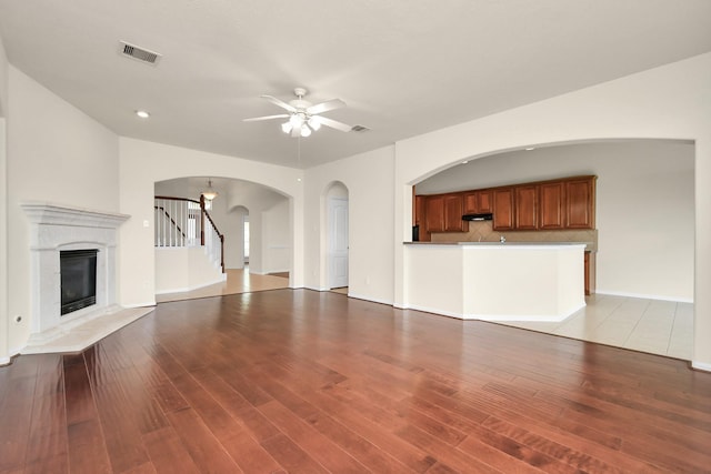 unfurnished living room with ceiling fan and light hardwood / wood-style floors