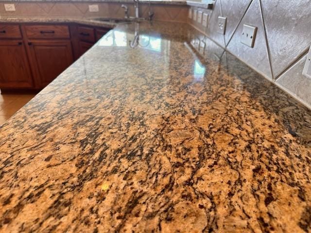 kitchen with stone countertops and sink